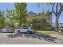 Street view of a handsome brick apartment building with mature trees and green lawn at 108 W Byers Pl # G1, Denver, CO 80223