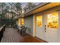 Inviting wooden deck with cozy chairs and glass doors leading to the home's interior at 18045 Arrowwood Dr, Monument, CO 80132