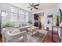 Bright living room with large windows, hardwood floors, modern furnishings, and stylish decor at 3438 N York St, Denver, CO 80205