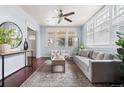 Cozy living room with a grey sofa, elegant rug, and natural light from the windows at 3438 N York St, Denver, CO 80205