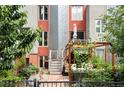The backyard features a private outdoor space with a pergola, seating, and vibrant greenery at 377 Pearl St # 5, Boulder, CO 80302
