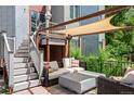 Relaxing backyard patio featuring an outdoor seating area, shade pergola, and well-manicured landscaping at 377 Pearl St # 5, Boulder, CO 80302