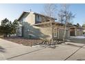 Side view of a two-story house with rock landscaping and a driveway at 16935 Buffalo Valley Path, Monument, CO 80132