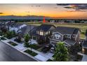 A high-angle view of a well-maintained home in a suburban area, showcasing its roof and surrounding landscape at 15595 E 47Th Dr, Denver, CO 80239