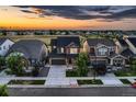 Aerial view of a modern two-story home with well-kept landscaping and a spacious driveway in a suburban neighborhood at 15595 E 47Th Dr, Denver, CO 80239