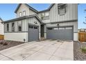 Attractive two-story home with a two-car garage and appealing exterior lighting at 154 Cortona Pl, Castle Pines, CO 80108