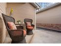A detailed view of the relaxing front porch seating area with wicker chairs and a small table at 8112 Gray Ct # 394, Arvada, CO 80003