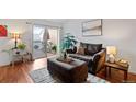 Bright living room features a comfortable sofa, an ottoman, and natural light at 8112 Gray Ct # 394, Arvada, CO 80003