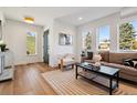 Cozy living room featuring natural light, hardwood floors, and stylish furnishings at 3430 W 25Th Ave, Denver, CO 80211