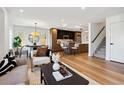 Open-concept living space with hardwood flooring, seamless flow between living, dining, and kitchen areas at 3430 W 25Th Ave, Denver, CO 80211