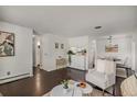 Open concept living room with hardwood floors and ample natural light at 64 Nome Way # A, Aurora, CO 80012
