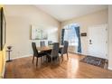 Open concept dining area features a large window, high ceilings, and hardwood floors at 9314 Wiltshire Dr, Highlands Ranch, CO 80130