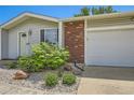 Close-up of the home's exterior, featuring a brick facade, garage, and landscaped front yard at 9146 W 89Th Ct, Broomfield, CO 80021