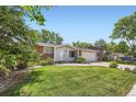Beautiful home with a green lawn and mature trees, complemented by an attached garage at 9146 W 89Th Ct, Broomfield, CO 80021