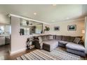 Comfortable living room featuring a large sectional sofa, hardwood floors, and stylish decor at 9146 W 89Th Ct, Broomfield, CO 80021