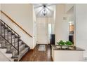 Bright foyer with wood floors, staircase, and views into the dining and living spaces at 4071 E 126Th Pl, Thornton, CO 80241