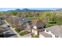 An aerial view of a home with a nearby tennis court and stunning mountain views at 4059 Nevis St, Boulder, CO 80301