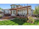 Relaxing backyard patio area with pergola, outdoor seating, barbecue, and lush garden in a private yard at 4059 Nevis St, Boulder, CO 80301
