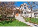 Beautiful home with a well-manicured lawn and flowering shrubs enhancing the front entrance at 4059 Nevis St, Boulder, CO 80301