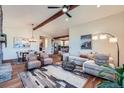Open-concept living room featuring hardwood floors, a comfortable seating area, and great natural light at 7201 W Asbury Pl, Lakewood, CO 80227