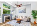 Sunlit living room with a fireplace, large windows, and stylish decor at 8199 Welby Rd # 4106, Denver, CO 80229