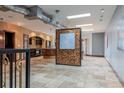 Open floor plan featuring travertine flooring, brick accents, and artistic lighting at 2150 Curtis St, Denver, CO 80205