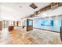 Large living room boasts skylights, ductwork, and travertine floors providing a modern and airy aesthetic at 2150 Curtis St, Denver, CO 80205