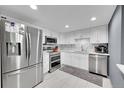 Modern kitchen featuring stainless steel appliances, sleek white cabinets, and marble backsplash at 14300 E Marina Dr # 109, Aurora, CO 80014