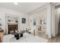 Bright living room with fireplace, modern furniture, and hardwood floors at 2707 N Lafayette St, Denver, CO 80205