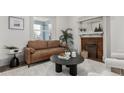 Cozy living room with a comfortable sofa, fireplace, and stylish decor at 2707 N Lafayette St, Denver, CO 80205