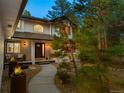 Charming front entrance with a welcoming walkway and a cozy porch seating area at 1935 Poncha Ct, Larkspur, CO 80118