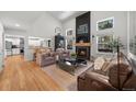 Bright living room with a fireplace, large windows, and hardwood floors at 1935 Poncha Ct, Larkspur, CO 80118