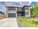 Contemporary two-story home with a two-car garage, landscaped front yard, and modern design elements at 23708 E 42Nd Ave, Aurora, CO 80019
