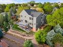 Aerial view of home with deck, fenced yard, garden, mature trees and backyard landscaping at 7411 S Crescent Ct, Littleton, CO 80120