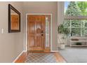 Home foyer features a hardwood floor, high ceilings, large front door, and contemporary decorations at 7411 S Crescent Ct, Littleton, CO 80120