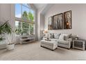 Living room with vaulted ceilings, large windows, comfortable seating, and tasteful decor at 7411 S Crescent Ct, Littleton, CO 80120