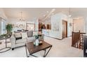 Spacious living area with open layout, neutral tones, and seamless flow to dining and kitchen areas at 2288 S Depew St, Lakewood, CO 80227