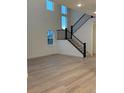 Bright living room with hardwood floors, staircase, and large windows allowing natural light at 5626 W 142Nd Ave, Broomfield, CO 80020