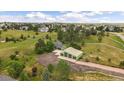 Gorgeous aerial view of the property showcasing the house and spacious grounds at 3672 Deer Creek Dr, Parker, CO 80138