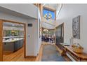 Bright foyer with high ceilings, hardwood floors, and views into the dining room and kitchen at 9 Red Fox Ln, Littleton, CO 80127