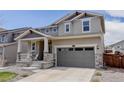 Inviting two-story home with a cozy front porch and a two-car garage, presenting a warm and welcoming facade at 1246 Blackhaw St, Elizabeth, CO 80107