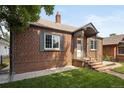 A charming brick home with a well-manicured lawn and inviting entrance at 4419 W 34Th Ave, Denver, CO 80212