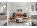 Cozy living room with a leather sofa and glass-topped coffee table at 4419 W 34Th Ave, Denver, CO 80212