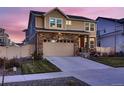 Inviting home boasting stone detailing, green lawn, and a convenient two-car garage at 4526 N Quatar Ct, Aurora, CO 80019