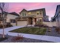 Attractive home featuring stone accents, well-kept lawn, and a driveway leading to a two-car garage at 4526 N Quatar Ct, Aurora, CO 80019