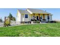 Charming one-story home with a covered front porch and well-maintained lawn at 10691 County Road 23, Fort Lupton, CO 80621