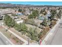 An aerial view of a beautiful landscaped property showcasing the home and surrounding area with mountain views at 335 Jefferson St, Monument, CO 80132