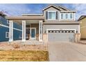 Charming two-story home with a covered front porch and well-maintained landscaping in a suburban neighborhood at 3525 E 139Th Pl, Thornton, CO 80602