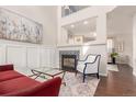 Cozy living room with a fireplace, stylish decor, and ample natural light, perfect for relaxing and entertaining at 3525 E 139Th Pl, Thornton, CO 80602