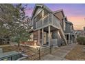 Charming two-story home featuring a cozy front porch and well-maintained landscaping at 14399 E Grand Dr # 150, Aurora, CO 80015